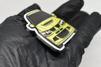 Side angle view showing 3D layered detail of yellow Mitsubishi Lancer Evolution 8 keychain by LayerPlay Pocket Motors