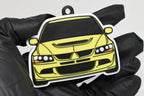 3D printed yellow Mitsubishi Lancer Evolution 8 keychain held in hand, front view detail by LayerPlay Pocket Motors
