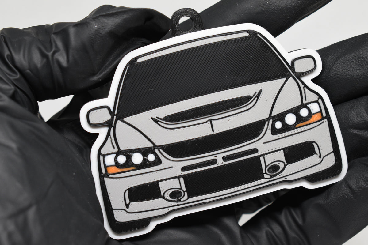 3D printed light gray Mitsubishi Lancer Evolution 9 keychain held in hand, front view detail by LayerPlay Pocket Motors