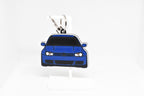 Pocket Motors MK4 Golf R32 keychain displayed on a white stand with metal ring and clip.