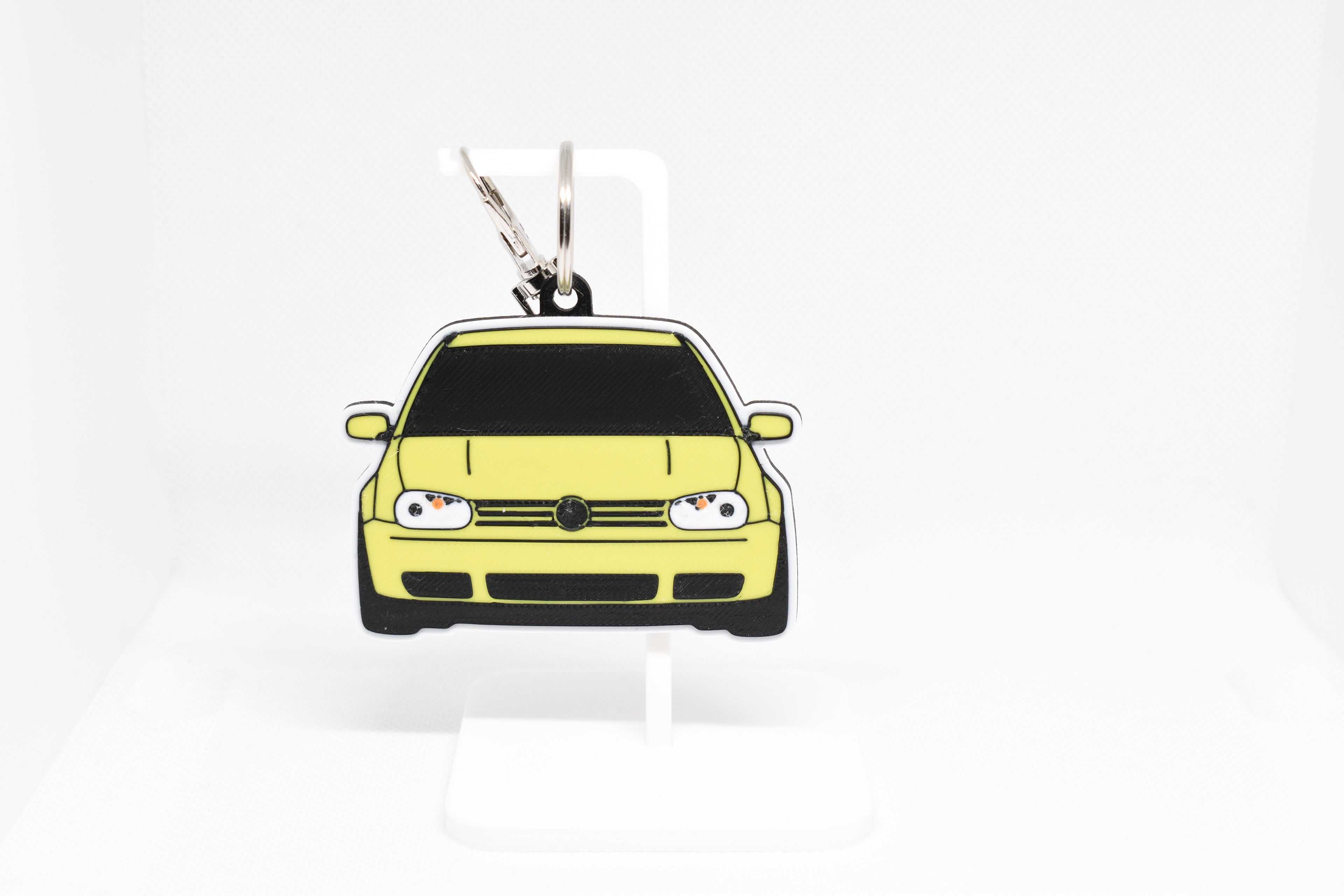 Pocket Motors MK4 GTI keychain displayed on a white stand with metal ring and clip.