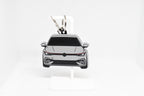 Pocket Motors MK8 GTI keychain displayed on a white stand with metal ring and clip.