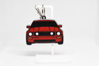 Pocket Motors Mustang S197 keychain displayed on a white stand with metal ring and clip.