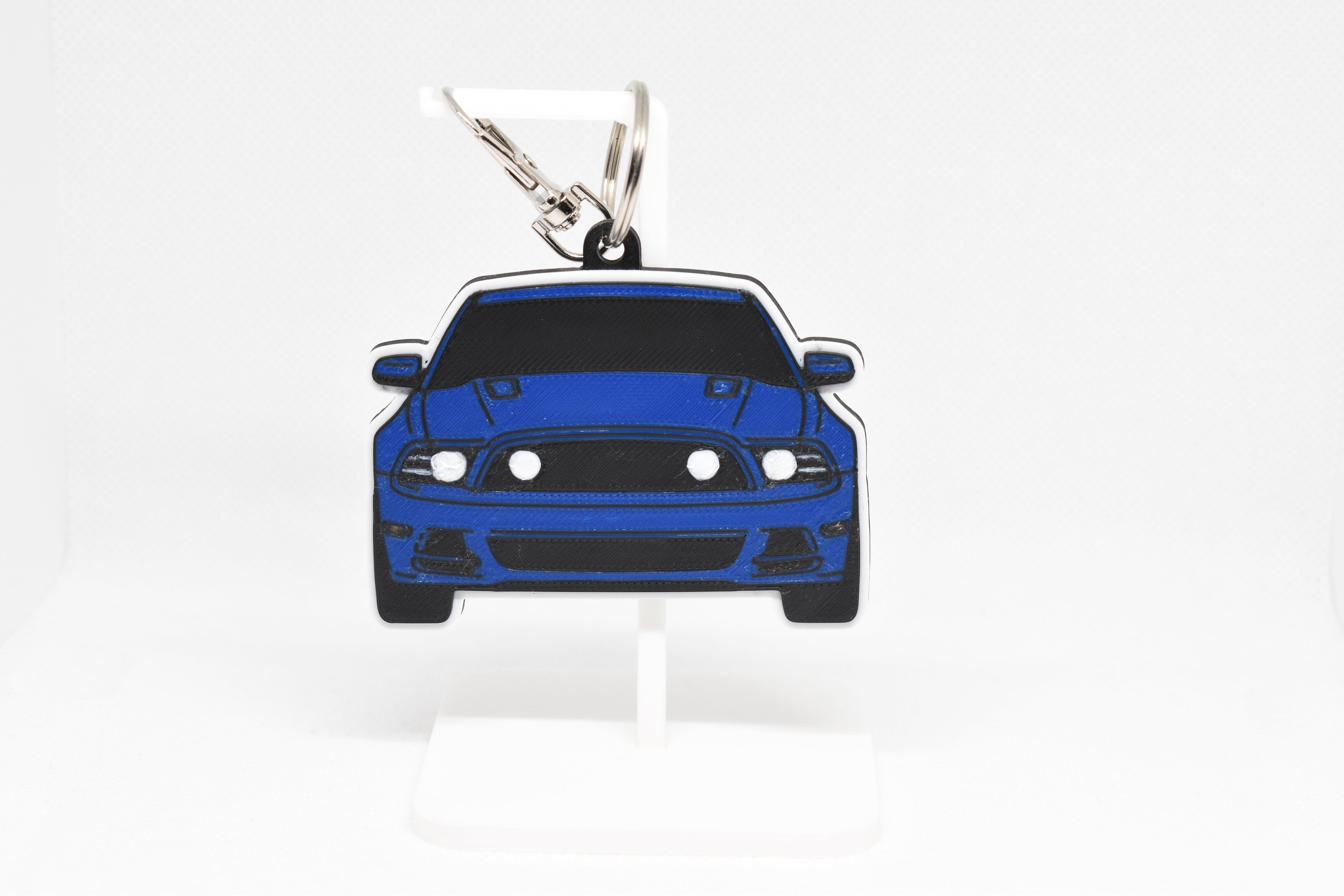 Pocket Motors Mustang S197 GT facelift keychain displayed on a white stand with metal ring and clip.