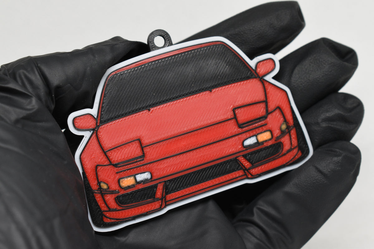3D printed red Nissan 240SX S13 keychain held in hand, front view detail by LayerPlay Pocket Motors