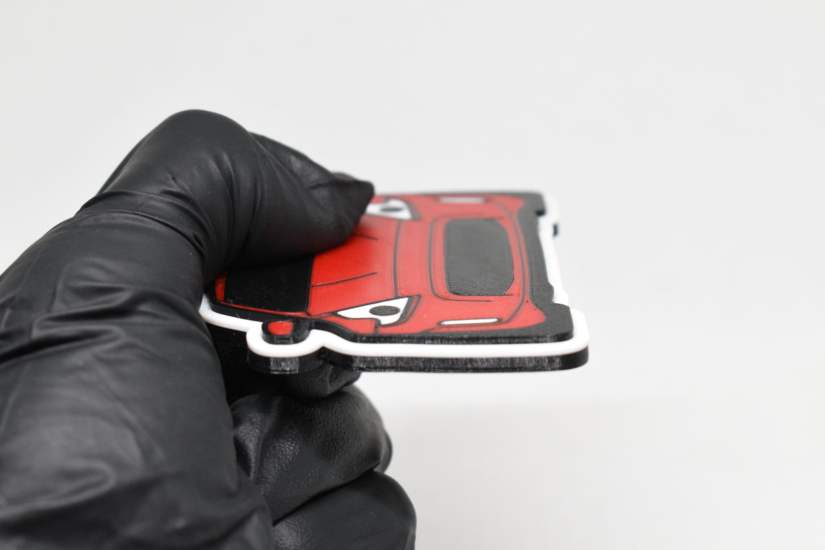 Side angle view showing 3D layered detail of red Nissan 370Z keychain by LayerPlay Pocket Motors