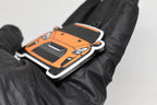 Side angle view showing 3D layered detail of orange Nissan GT-R R35 keychain by LayerPlay Pocket Motors
