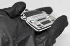 Side angle view showing 3D layered detail of light gray Nissan Skyline GT-R R34 keychain by LayerPlay Pocket Motors