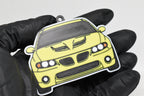 3D printed yellow Pontiac GTO 5th Gen keychain held in hand, front view detail by LayerPlay Pocket Motors