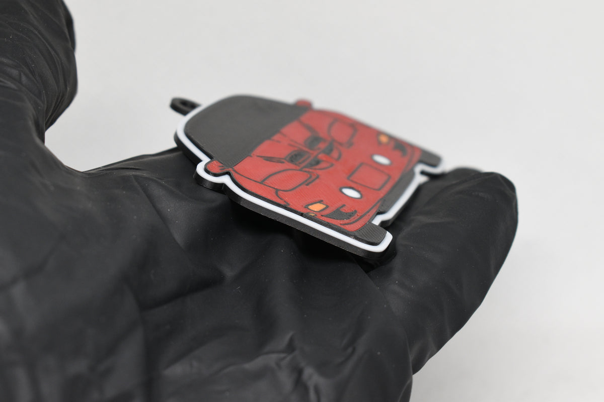 Side angle view showing 3D layered detail of red Pontiac Trans-Am WS6 4th Gen keychain by LayerPlay Pocket Motors