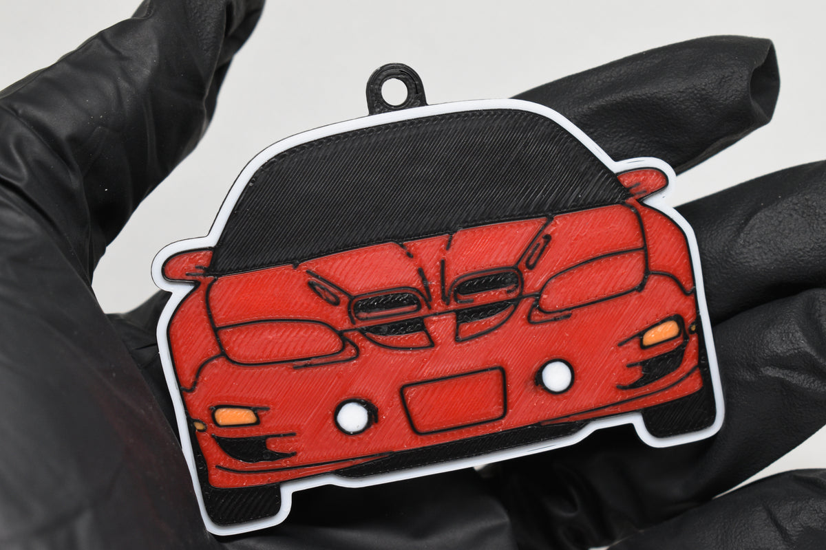 3D printed red Pontiac Trans-Am WS6 4th Gen keychain held in hand, front view detail by LayerPlay Pocket Motors