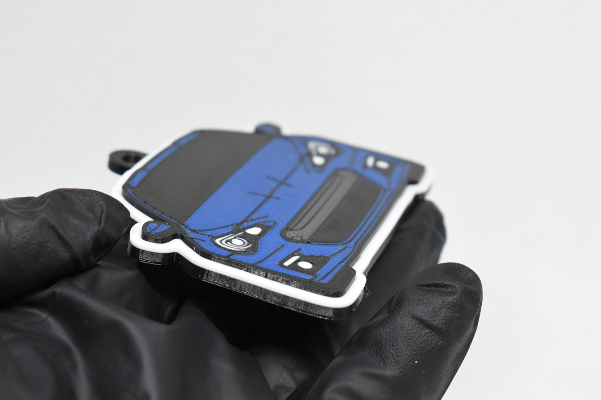 Side angle view showing 3D layered detail of blue Subaru BRZ 1st Gen keychain by LayerPlay Pocket Motors