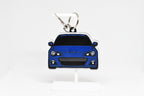 Layerplay Pocket Motors 1st‑gen Subaru BRZ 3D printed keychain displayed on a white stand.