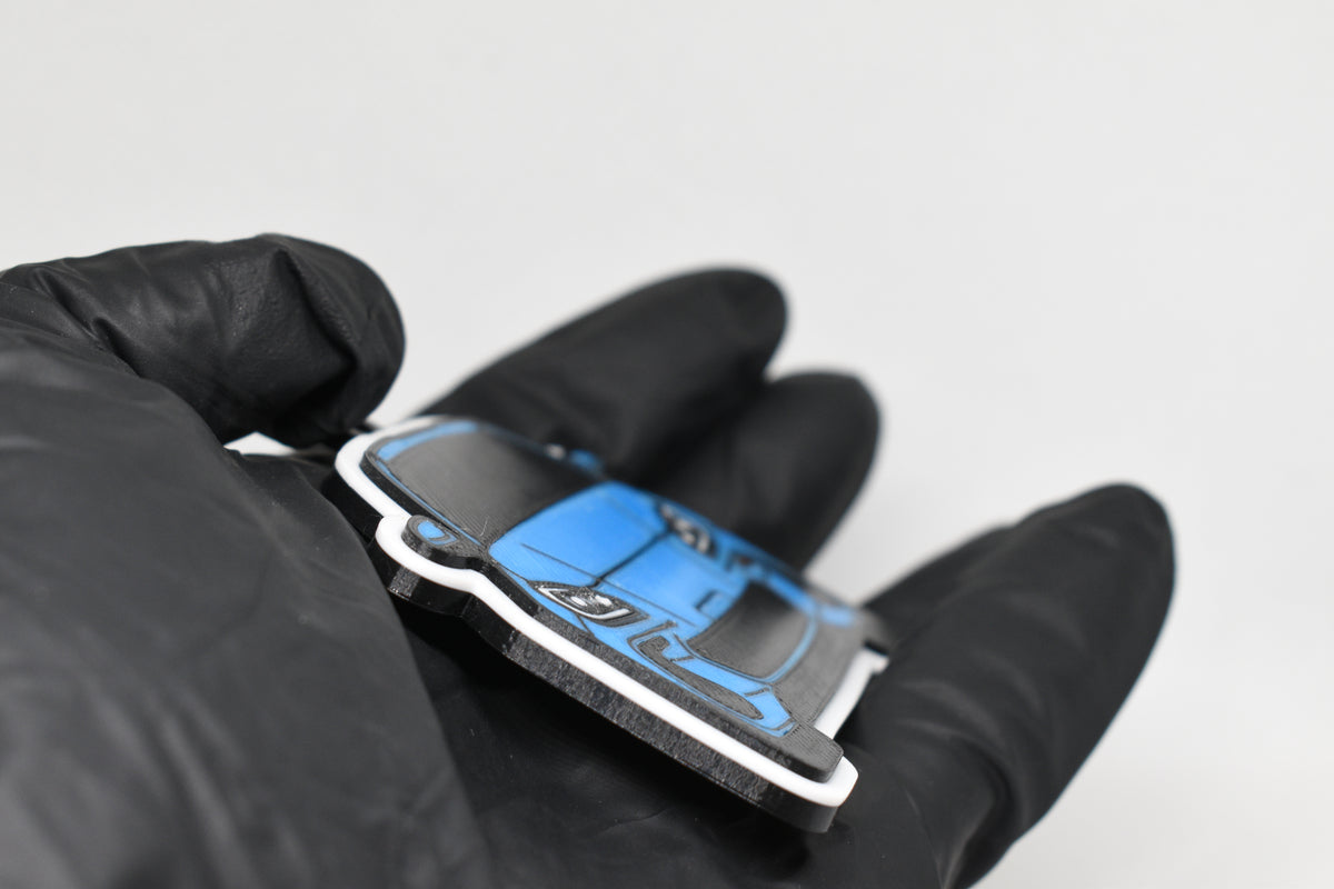 Side angle view showing 3D layered detail of light blue Subaru BRZ 2nd Gen keychain by LayerPlay Pocket Motors