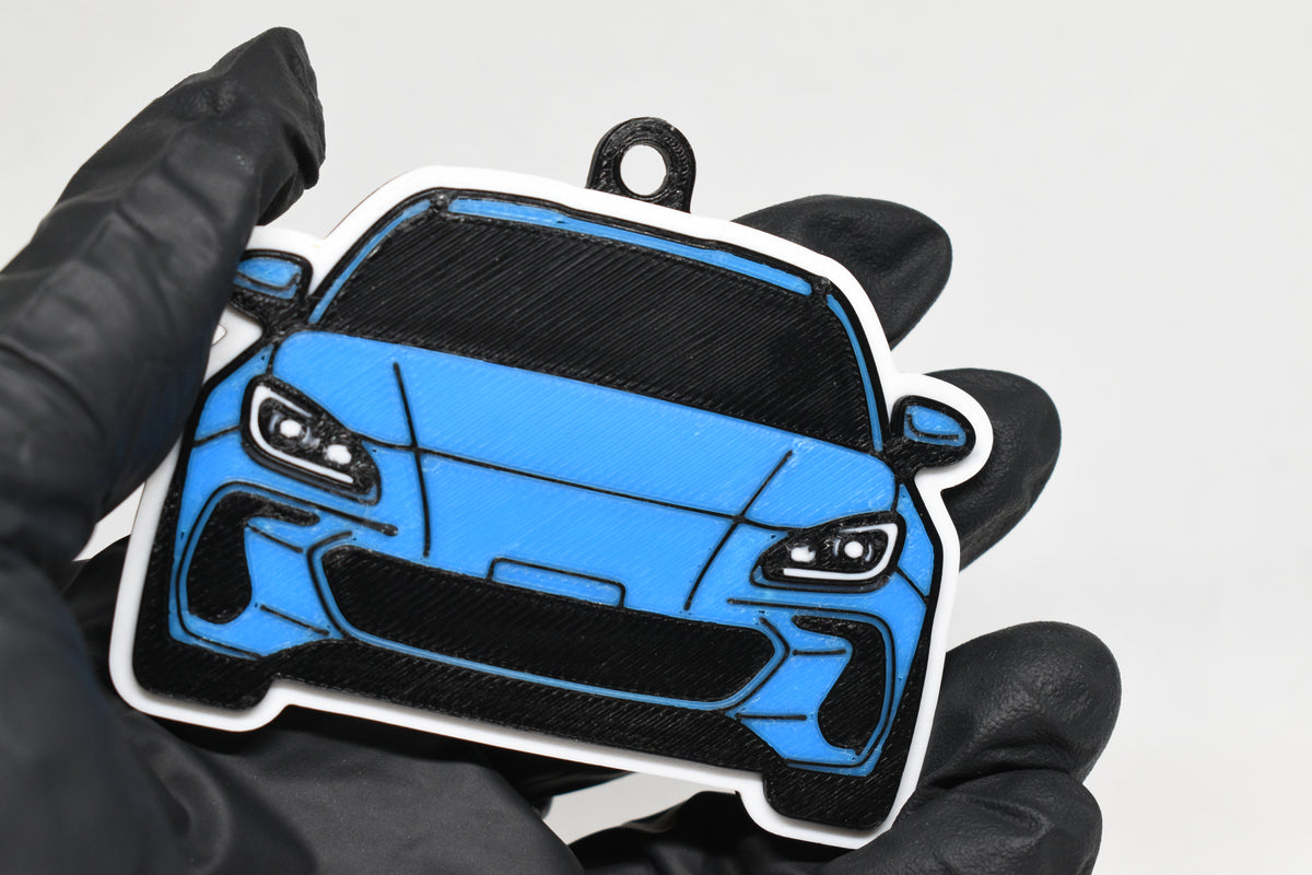 3D printed light blue Subaru BRZ 2nd Gen keychain held in hand, front view detail by LayerPlay Pocket Motors