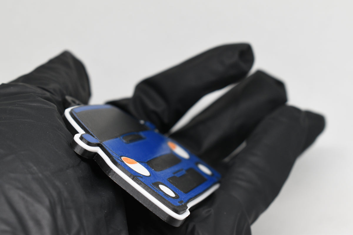 Side angle view showing 3D layered detail of blue Subaru WRX Bugeye keychain by LayerPlay Pocket Motors