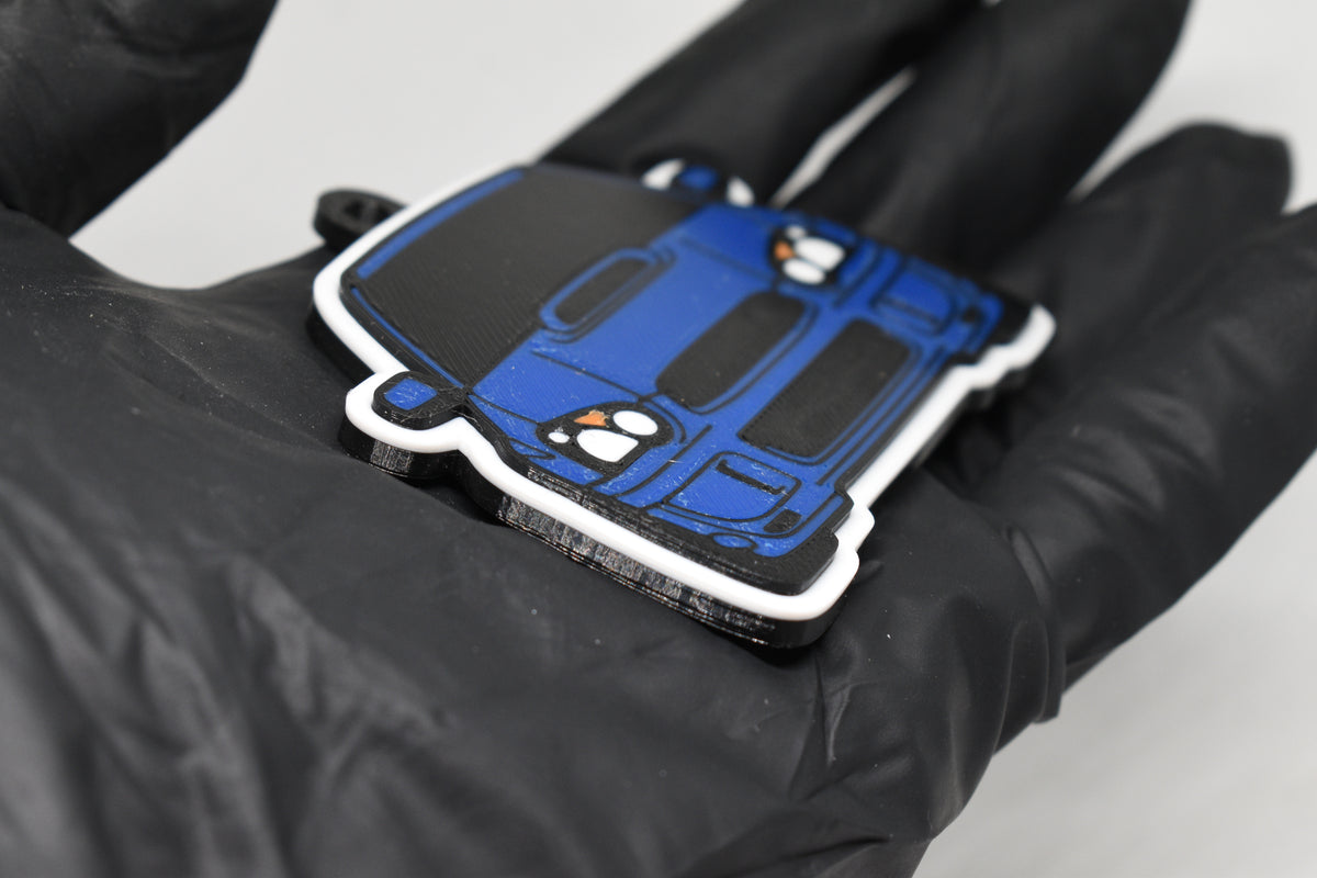 Side angle view showing 3D layered detail of blue Blobeye Subaru WRX STI keychain by LayerPlay Pocket Motors