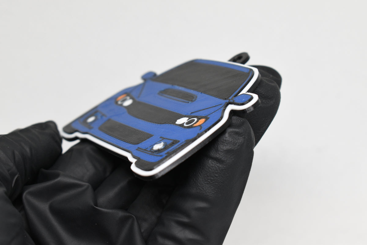 Side angle view showing 3D layered detail of blue Subaru WRX STI GR keychain by LayerPlay Pocket Motors