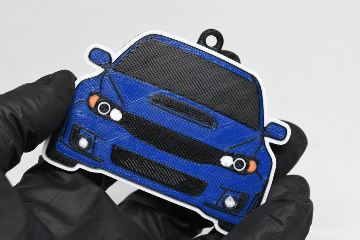 3D printed blue Subaru WRX STI GR keychain held in hand, front view detail by LayerPlay Pocket Motors