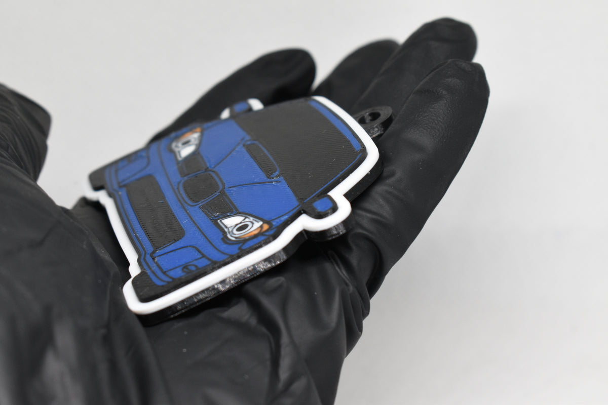 Side angle view showing 3D layered detail of blue Hawkeye Subaru WRX STI keychain by LayerPlay Pocket Motors