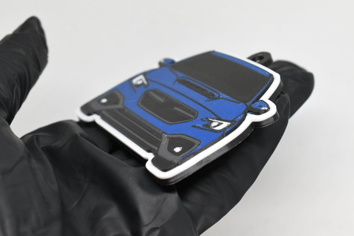 Side angle view showing 3D layered detail of blue Subaru WRX VB keychain by LayerPlay Pocket Motors