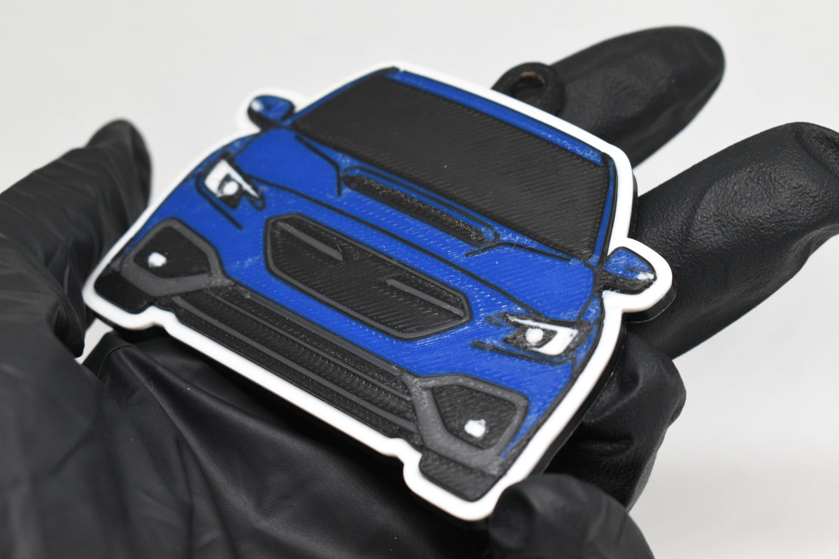 3D printed blue Subaru WRX VB keychain held in hand, front view detail by LayerPlay Pocket Motors