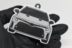 3D printed light gray Toyota GR Corolla pre-facelift keychain held in hand, front view detail by LayerPlay Pocket Motors