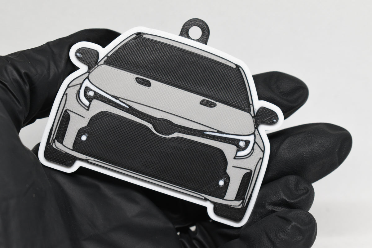 3D printed light gray Toyota GR Corolla pre-facelift keychain held in hand, front view detail by LayerPlay Pocket Motors