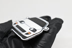 Side angle view showing 3D layered detail of white Toyota Supra Mk4 keychain by LayerPlay Pocket Motors