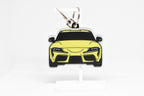 Pocket Motors Toyota Supra MK5 keychain displayed on a white stand with metal ring and clip.
