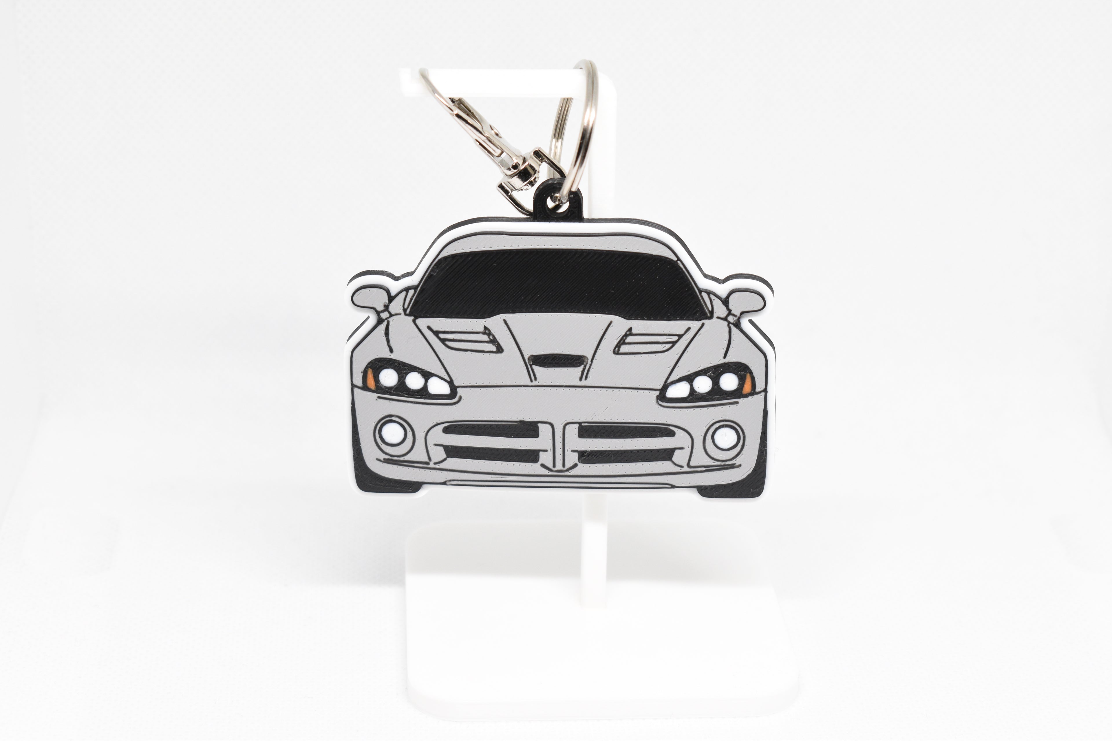 Pocket Motors Viper 4th Gen keychain displayed on a white stand with metal ring and clip.