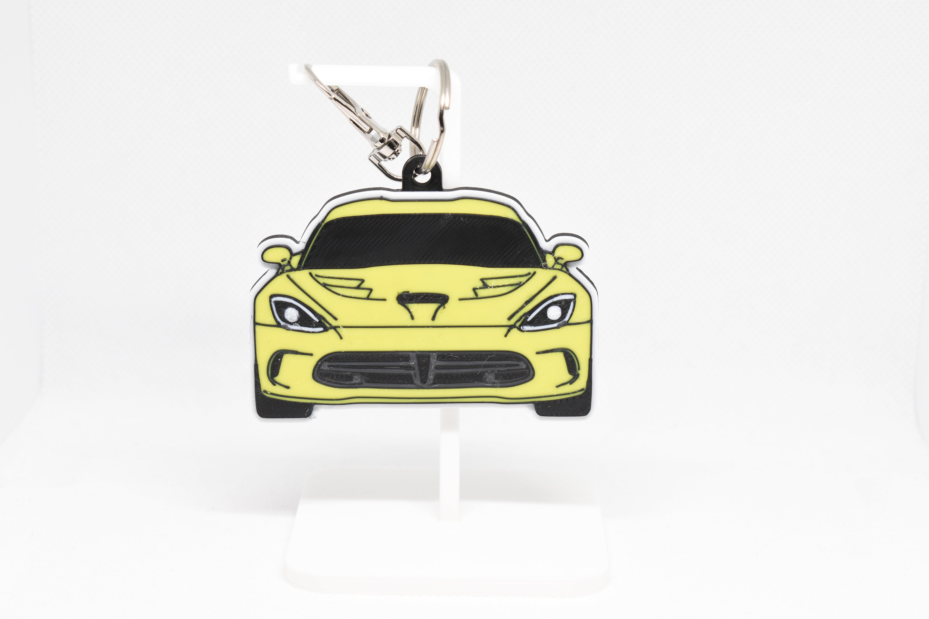 Pocket Motors Viper 5th Gen keychain displayed on a white stand with metal ring and clip.