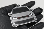 3D printed light gray Volkswagen GTI MK6 keychain held in hand, front view detail by LayerPlay Pocket Motors