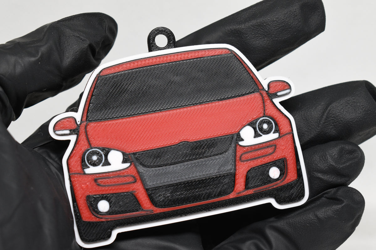 3D printed red Volkswagen MK5 GTI keychain held in hand, front view detail by LayerPlay Pocket Motors
