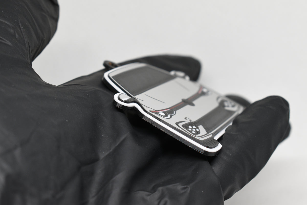 Side angle view showing 3D layered detail of light gray Volkswagen MK8 GTI keychain by LayerPlay Pocket Motors