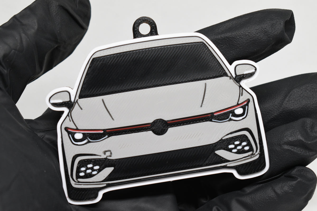 3D printed light gray Volkswagen MK8 GTI keychain held in hand, front view detail by LayerPlay Pocket Motors