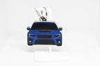 Pocket Motors WRX STI VA chassis facelift keychain displayed on a white stand with metal ring and clip.