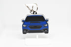 Pocket Motors WRX VB chassis keychain displayed on a white stand with metal ring and clip.