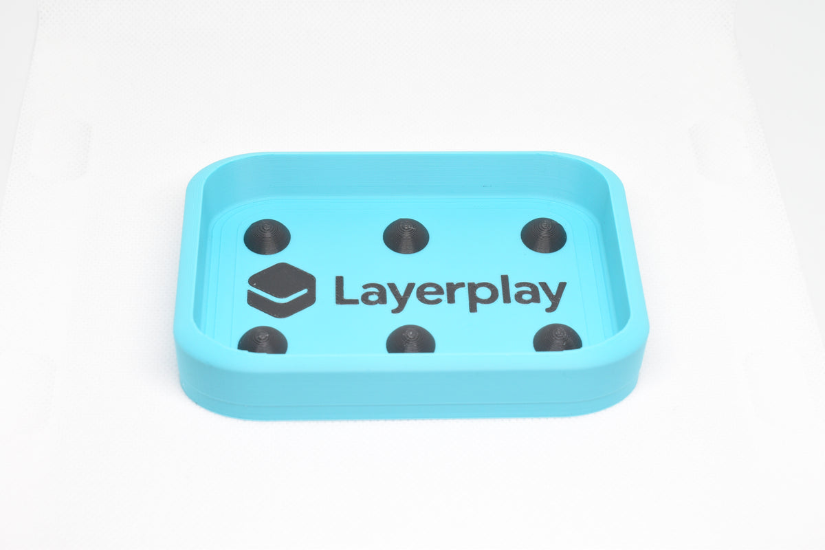 Cyan 3D printed rectangular soap dish featuring six black raised domino nubs and LayerPlay logo branding