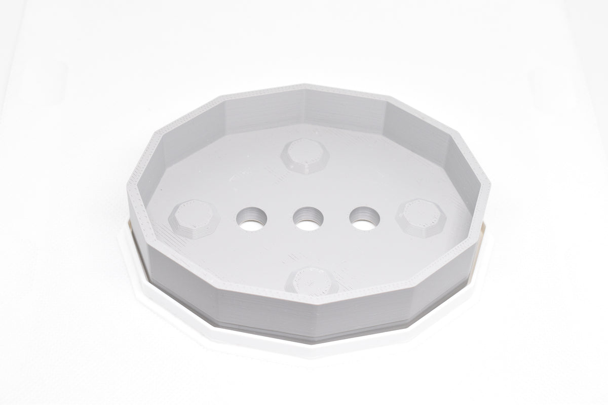 Top studio view of grey octagonal self-draining soap dish showing internal drainage holes and raised nubs by LayerPlay Solara