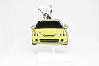 Yellow JDM Integra keychain displayed on a white stand with metal ring and clip.