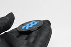 Side angle view showing raised 3D blue aquarius sign detail and thickness on black disc keychain by LayerPlay