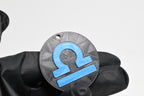 Hand in black glove holding 3D printed blue libra zodiac symbol keychain front view detail by LayerPlay