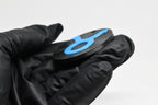 Side angle view showing raised 3D blue taurus sign detail and thickness on black disc keychain by LayerPlay